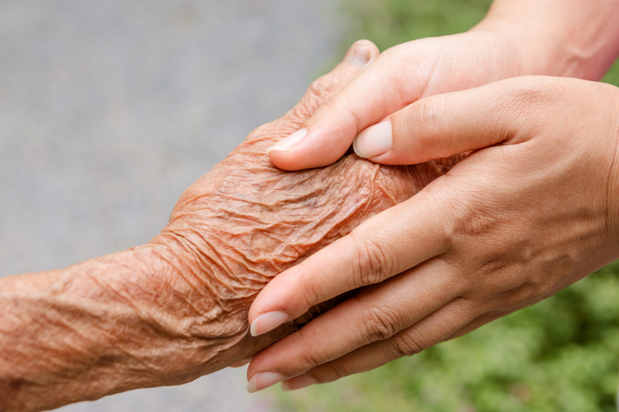 Senior and young holding hands with retro effect